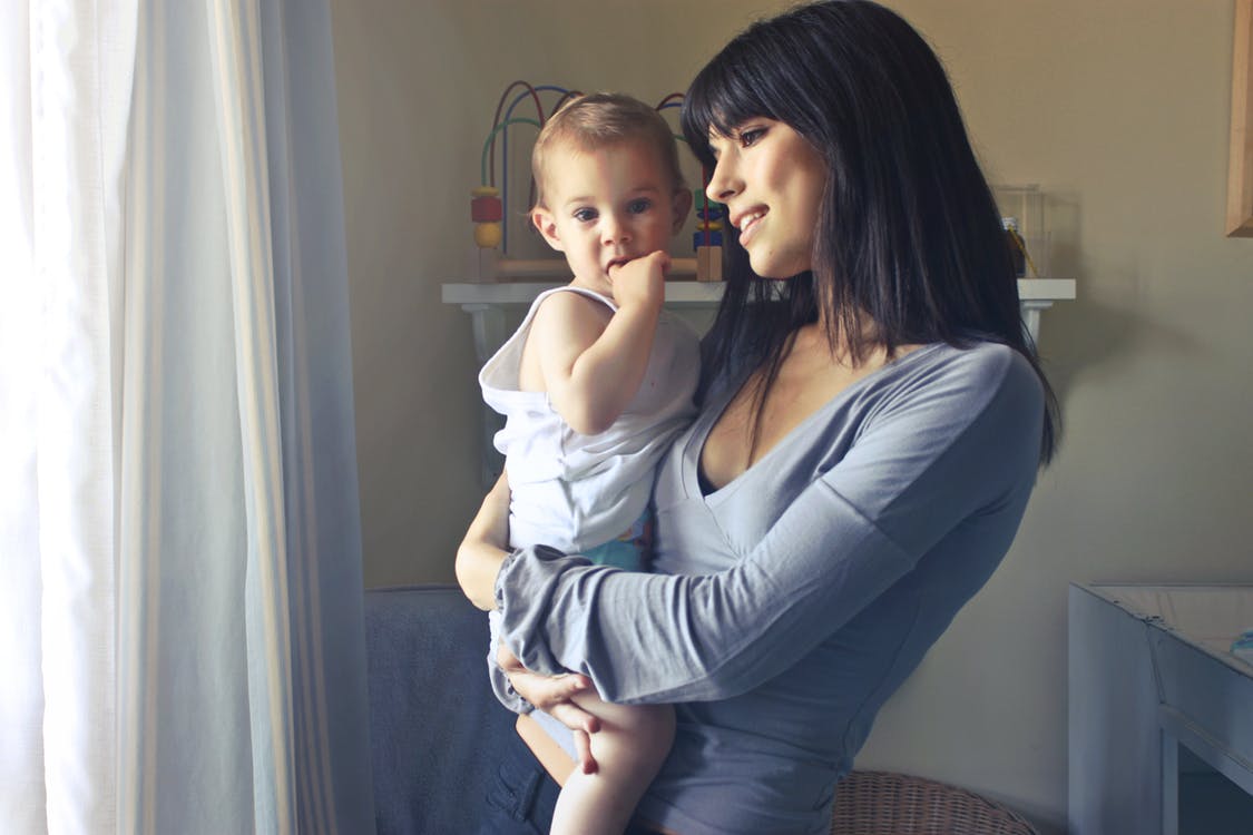 An adult calmly sitting with a child who is experiencing a strong emotion, modeling Montessori emotional support
