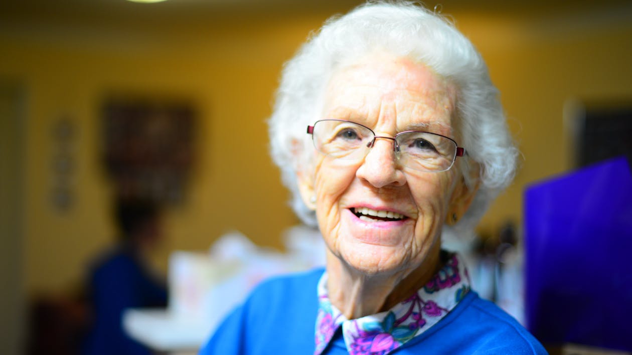 An older adult with dementia engaged in a hands-on Montessori-based activity with a caregiver
