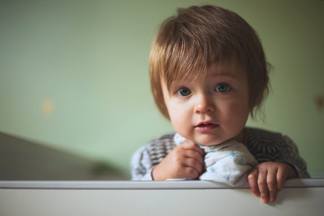 A toddler in mid-tantrum on the floor, illustrating the emotional intensity of the terrible twos phase