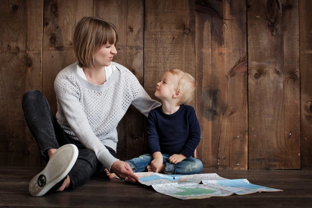 A trained Montessori guide presenting a lesson to a child in a classroom