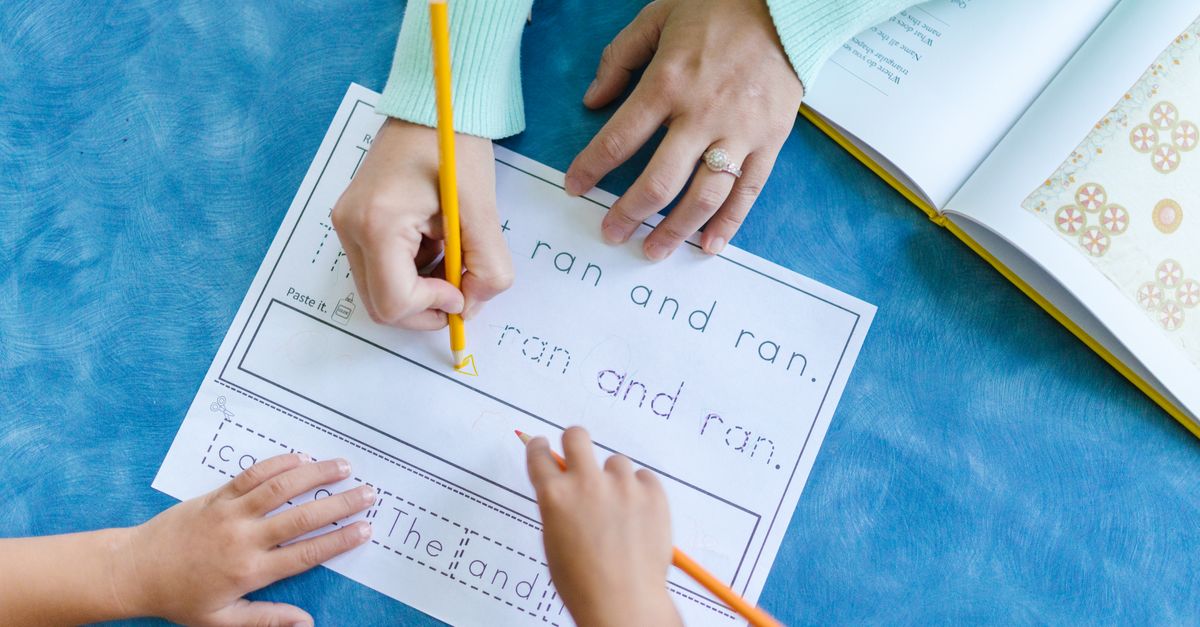 A child tracing letters with their fingers during a multisensory reading activity